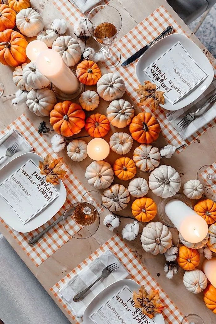 pinterest thanksgiving, small pumpkins, arranged as table runner, candles between them, plate settings, wooden table