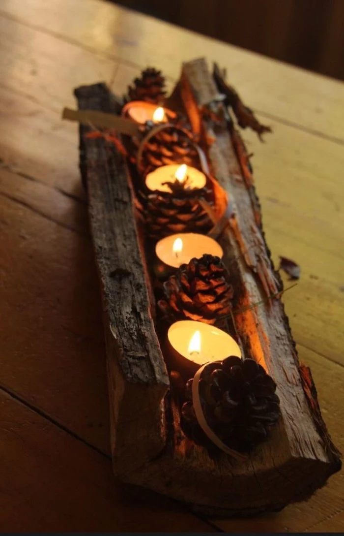 pine cones and candles, inside a wooden log, pinterest thanksgiving, wooden table