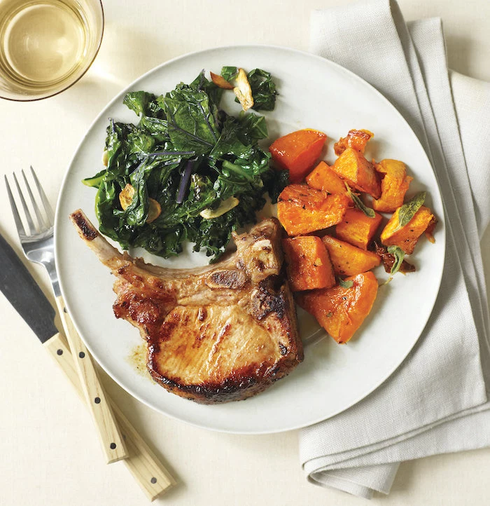 pork with cooked spinach and pumpkin, in white plate, what to make for dinner tonight, white cloth, white table
