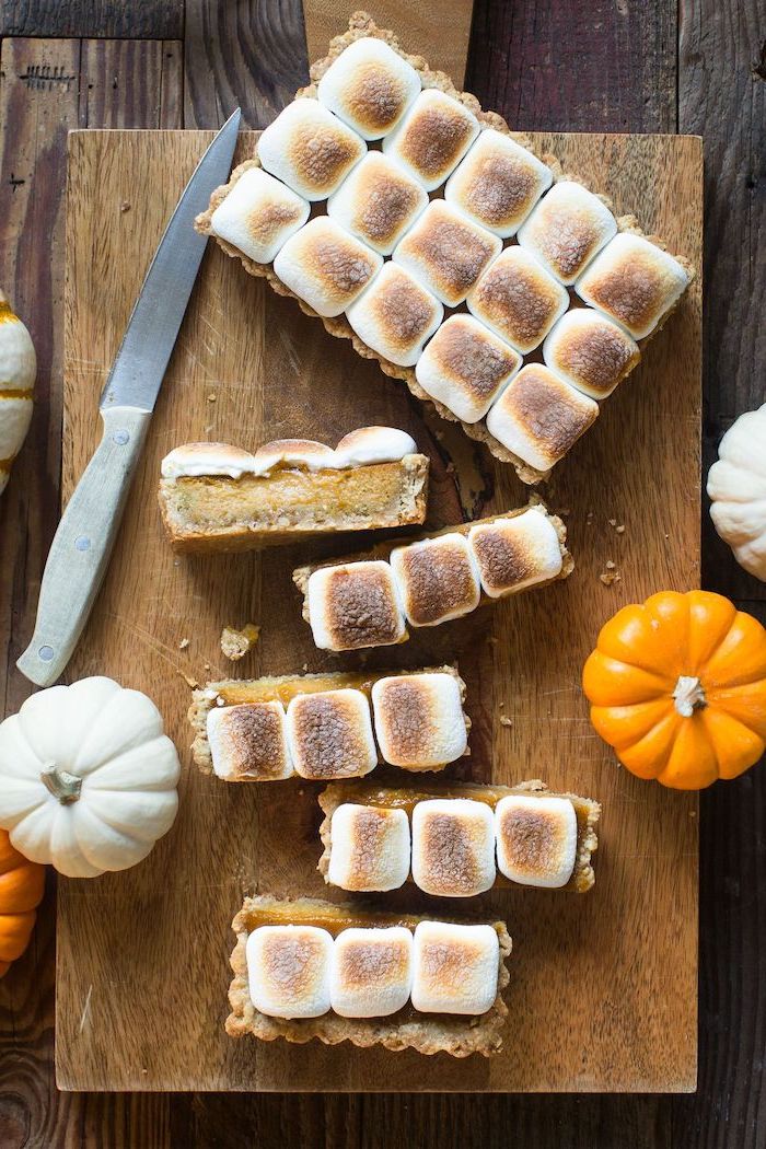 wooden board, thanksgiving desserts for kids, pumpkin tart, roasted marshmallow on top, wooden table