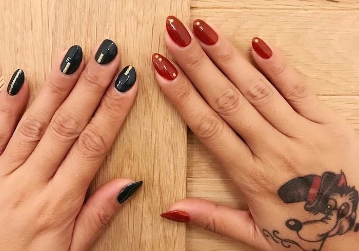 thanksgiving nail colors, two different manicures, black and red nail polish, hand tattoo, wooden table