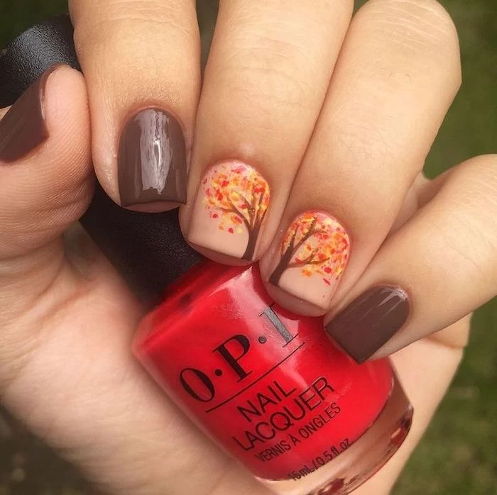 brown and nude, nail polish, thanksgiving nail colors, tree with orange, yellow leaves, nail decorations