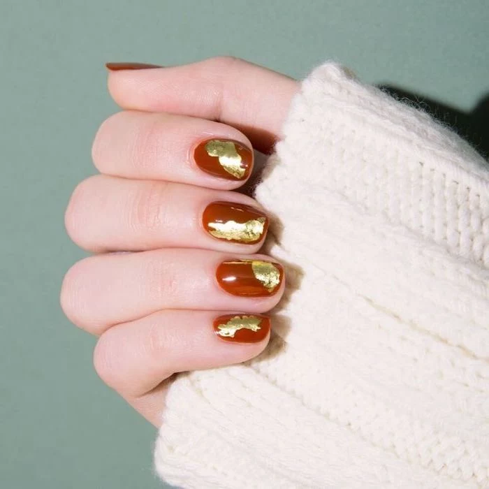 dark red, nail polish, thanksgiving nail colors, gold glitter, nail decorations, short squoval nails, white sweater