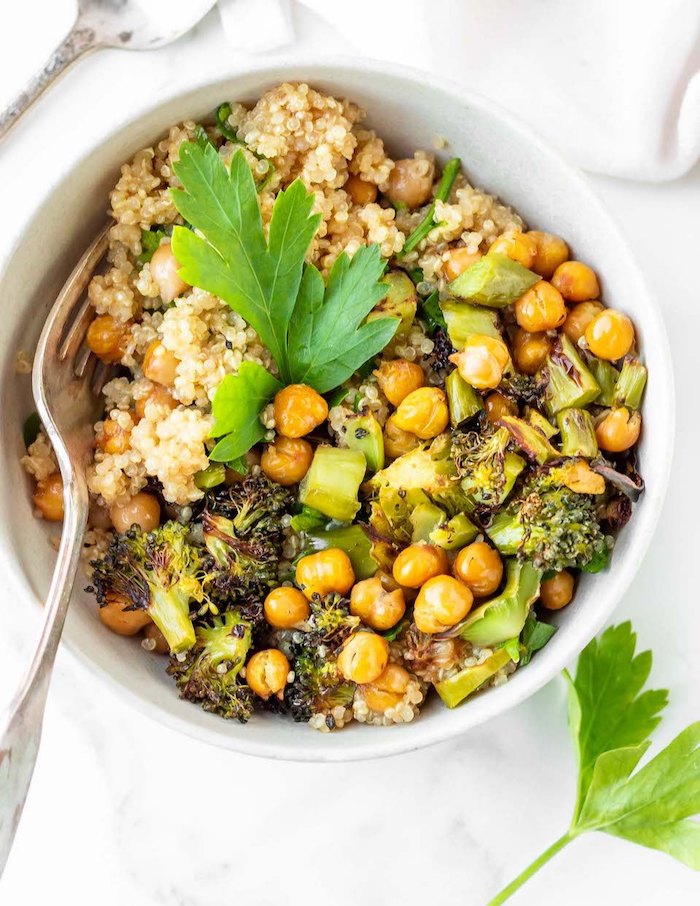 quinoa with chickpeas, broccoli and avocado, in white bowl, healthy dinners for two, white table, white cloth