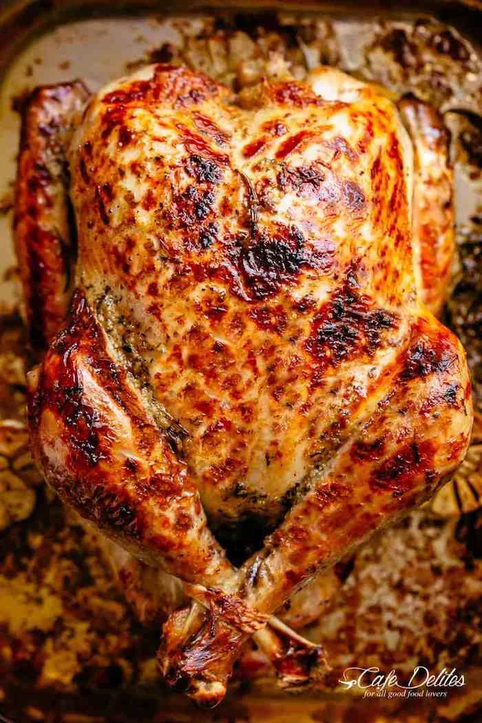 roasted turkey, how long to cook a turkey, covered with herbs and butter, in a pan
