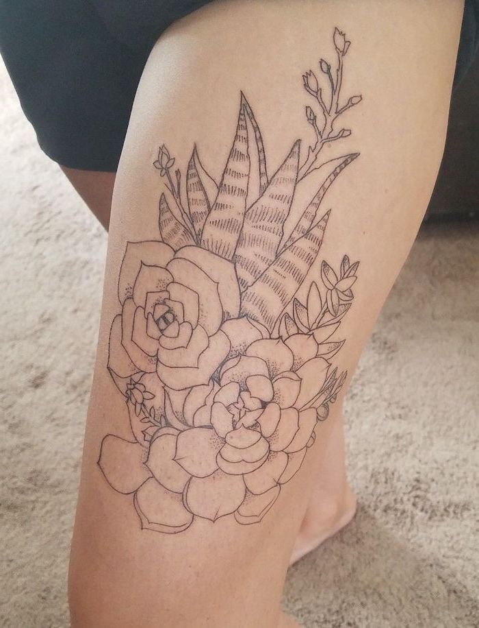 side thigh tattoo, flowers and aloe vera, black shorts, beige carpet