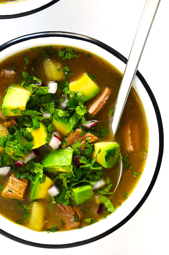 steak soup, weight loss diet, avocado slices, parsley garnish, in white bowl, silver spoon, white table