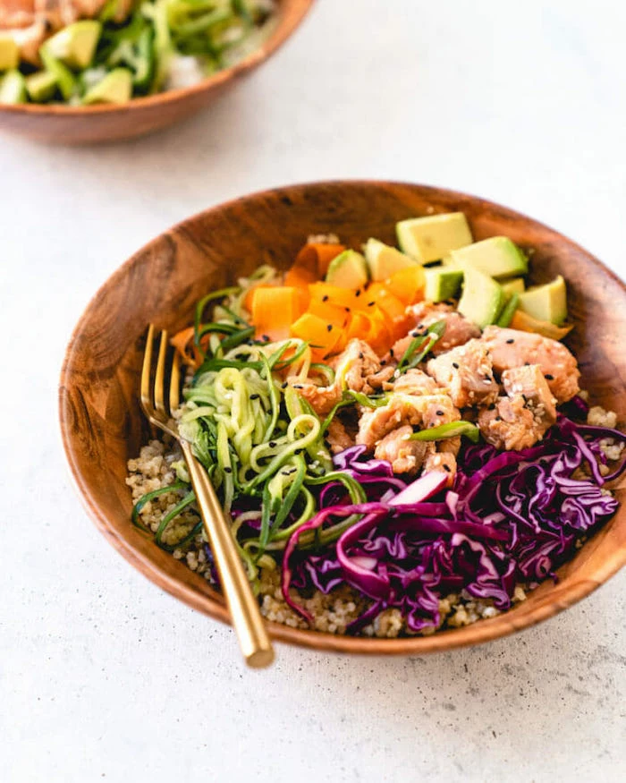 dinner ideas for tonight, spiralised carrots and zucchini, avocado and quinoa, seared salmon, in wooden bowls