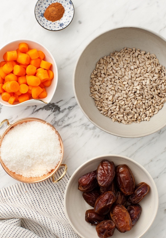 ingredients in white bowls, on marble countertop, peanut butter oatmeal balls, white cloth