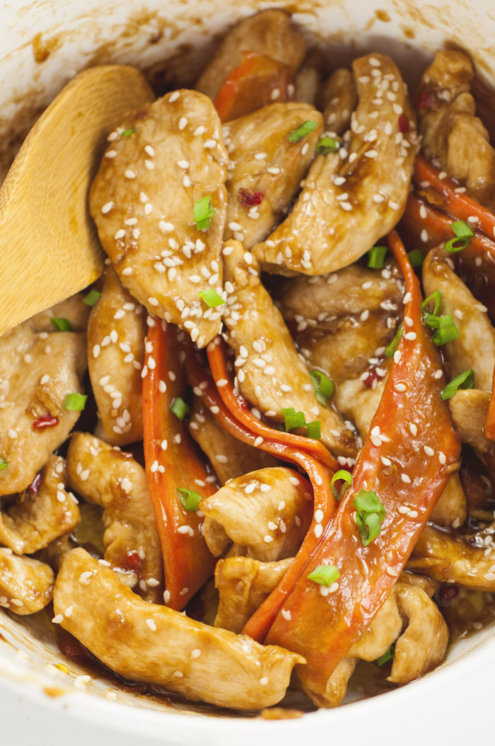 sesame chicken fillet, with carrot noodles, simple meal plan to lose weight, chives on top, wooden spatula