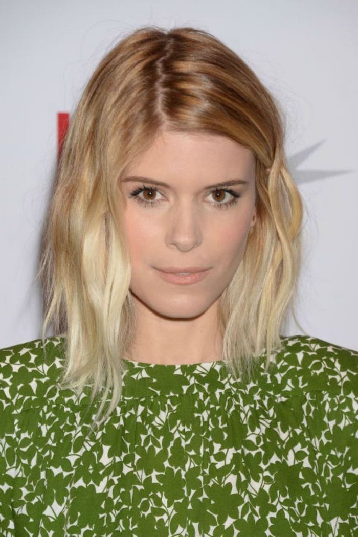 kate mara with blonde balayage hair, wearing green dress, layered haircuts with bangs, white background