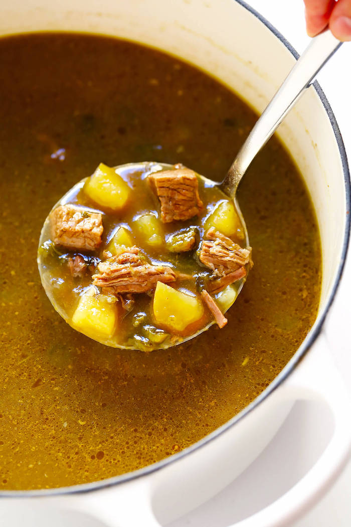 small ladle, steak soup, in a white bowl, weight loss diet, white background, chopped potatoes