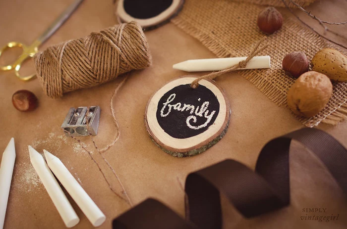 chalkboard on small wooden piece, chalk and scissors, thanksgiving decorating ideas, brown ribbon