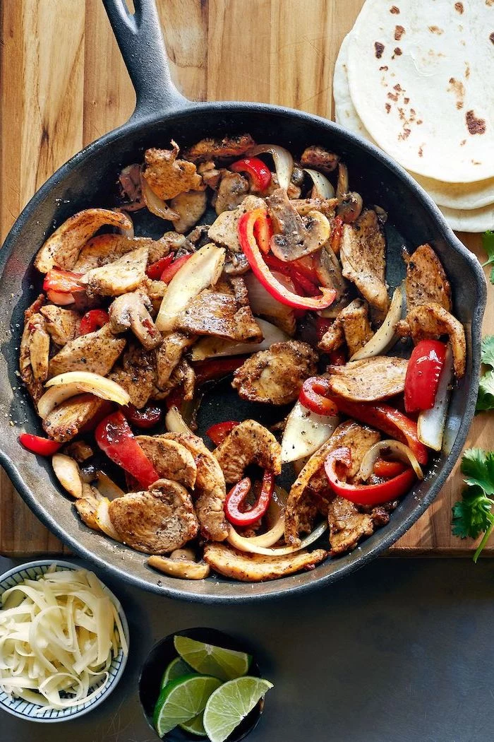 healthy dinners for two, stir fry chicken, with mushrooms and peppers, in a skillet, tortilla wraps, wooden board
