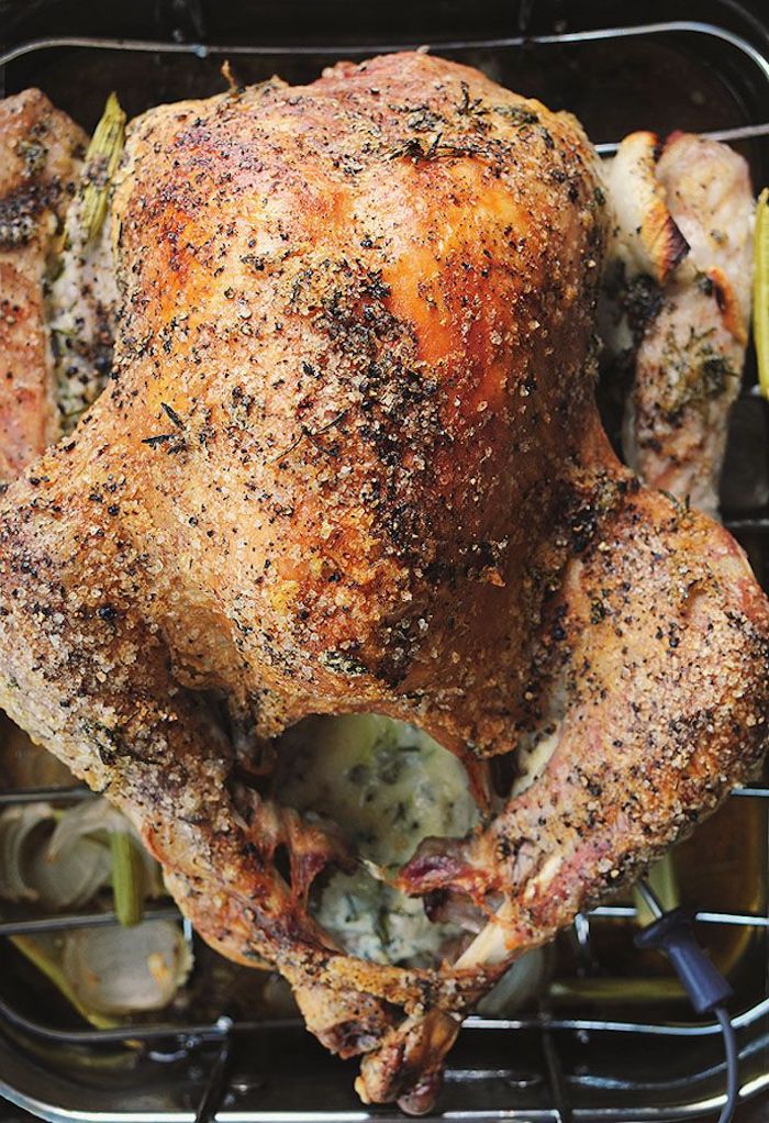 what temperature to cook a turkey, roasted turkey, stuffed with mayonnaise and herbs, herbs on top