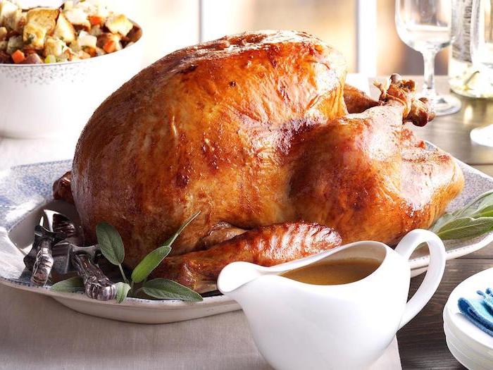 gravy in a jug, roasted turkey, fresh herbs, white plate, how to cook a thanksgiving turkey, thanksgiving dinner