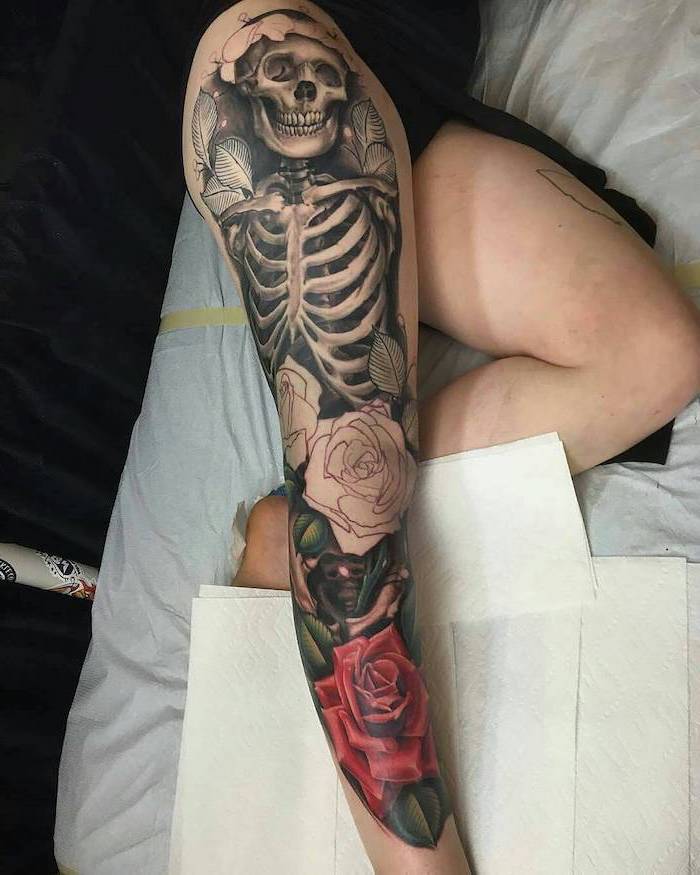 whole leg tattoo, sexy tattoos for women, skull and rib cage skeleton, red roses, white paper napkins
