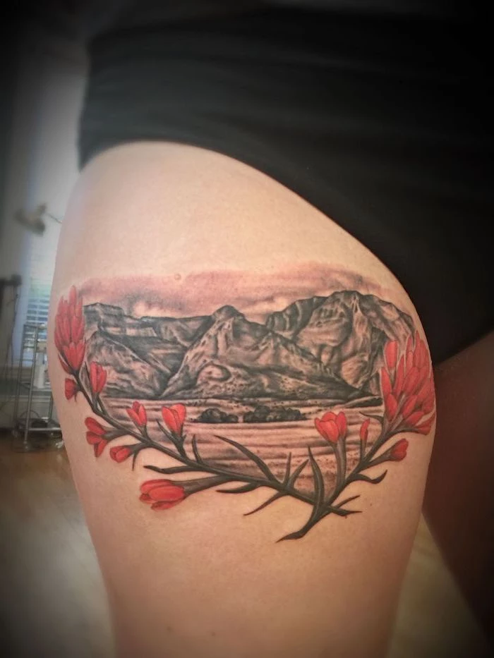 black shorts, upper thigh tattoo, mountain landscape, red flowers, wooden floor