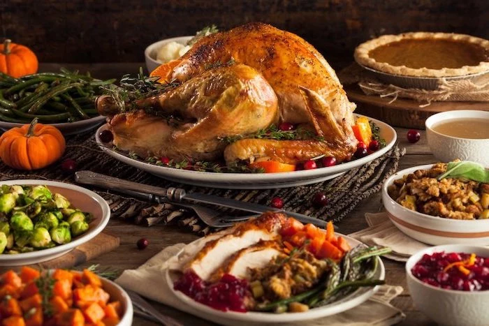 best thanksgiving turkey recipe, roasted turkey, white plate, cranberry sauce, wooden table, different meals