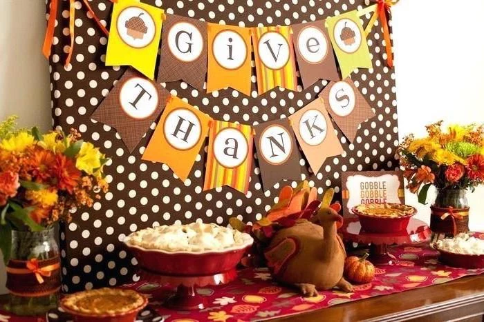 give thanks banner, stuffed toy turkey, thanksgiving home decorations, flower bouquets, dessert table