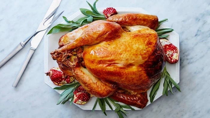 fresh herbs, pomegranate seeds, on the side, roasted turkey, white plate, best thanksgiving turkey recipe