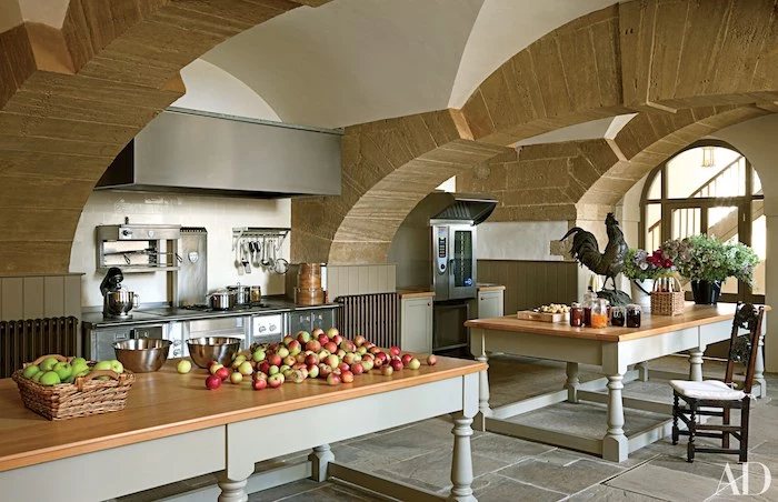 wooden kitchen islands, stone tiles on the ceiling, vaulted ceiling lighting, tiled floor, metal kitchen