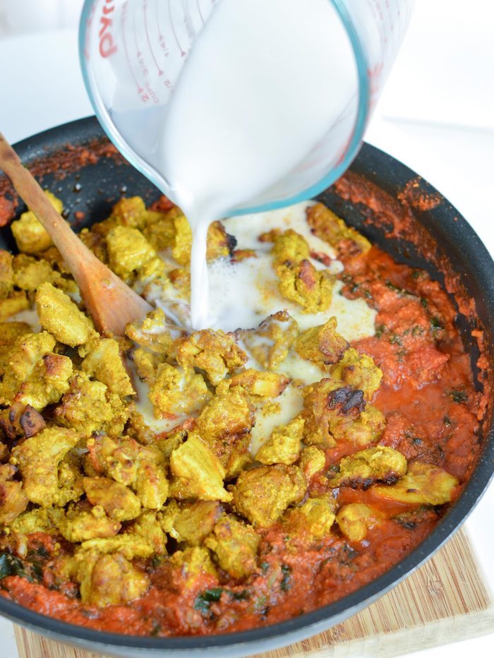 black skillet, tomato sauce, chicken cubes, milk poured out of a jug, best weight loss diet, wooden board