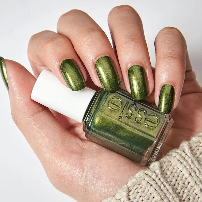 hand holding, nail polish bottle, metallic green, nail polish, short squoval nails, white background, pretty nail colors