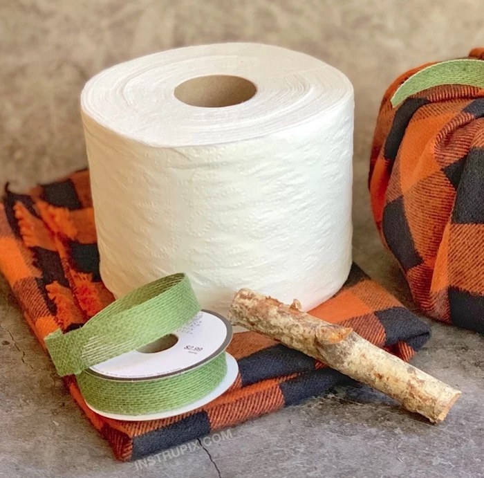 flannel table cloth, toilet paper roll, green ribbon, wooden stick, fall decor, step by step, diy tutorial
