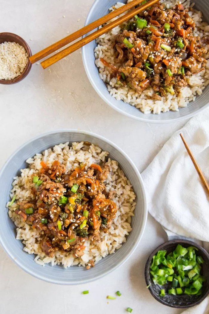 two bowls, teriyaki chicken, rice bowls, dinner ideas for two, wooden chopsticks, white table, white cloth