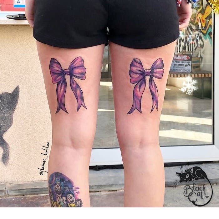 black shorts, back of thigh tattoos, sexy tattoos for women, two pink bows, on each leg