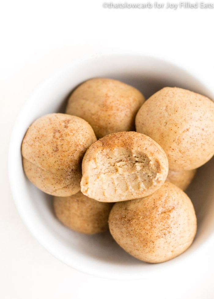 healthy energy balls recipe, with peanut butter, cinnamon powder on top, in white bowl