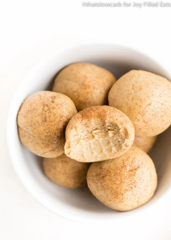 healthy energy balls recipe, with peanut butter, cinnamon powder on top, in white bowl
