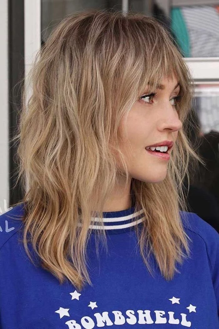 medium hairstyles 2019, wearing blue bombshell blouse, blonde hair with bangs