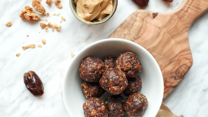 chocolate truffles, with nuts and dates, peanut butter, healthy energy balls recipe, wooden cutting board