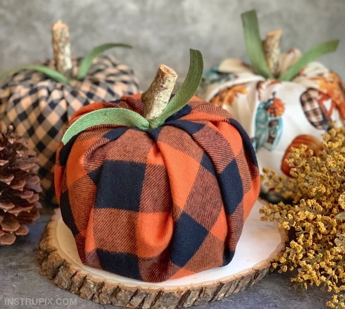 fall decor, step by step, diy tutorial, pumpkins made of flannel table cloth, on wooden logs, green ribbons