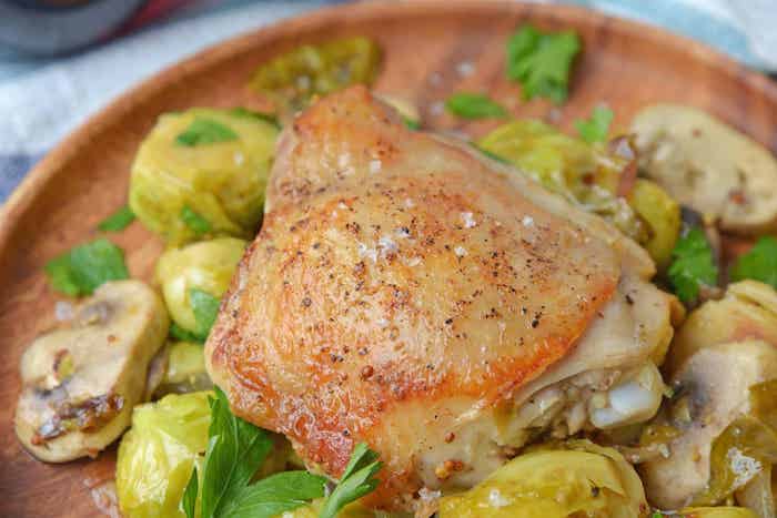 chicken dijon, with mushrooms, brussel sprouts, in wooden plate, easy weeknight meals, parsley for garnish