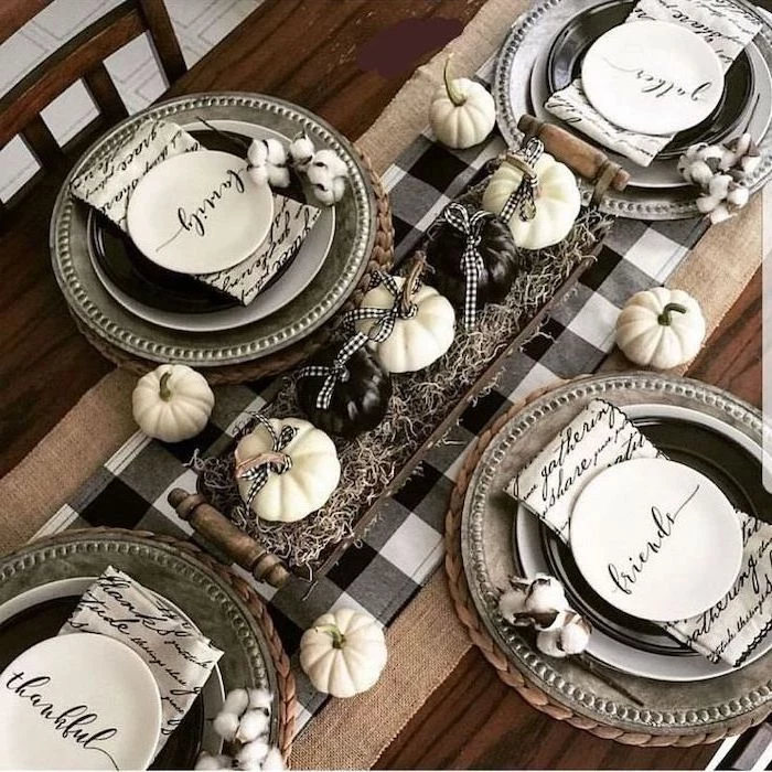 plate settings, white and black table runner, turkey decorations for thanksgiving, black and white pumpkin, in a wooden crate