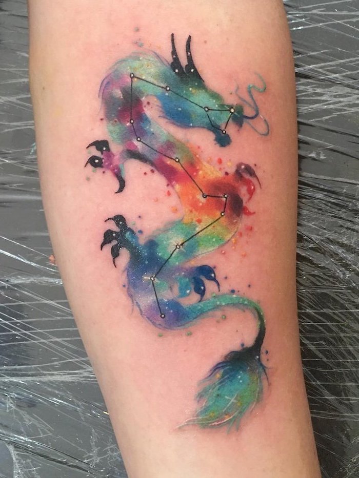 galaxy watercolor dragon, back of leg tattoo, japanese dragon tattoo, leg leaning on black leather chair