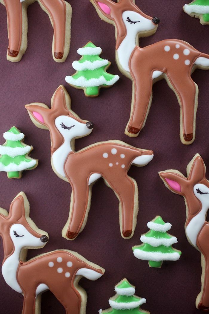 bambi shaped cookies, christmas tree shaped cookies, christmas cookie decorating ideas, placed on brown surface