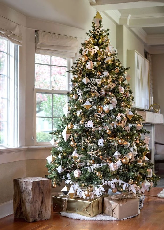tall tree decorated with gold and silver ornaments, presents underneath on white rug, how to decorate a christmas tree