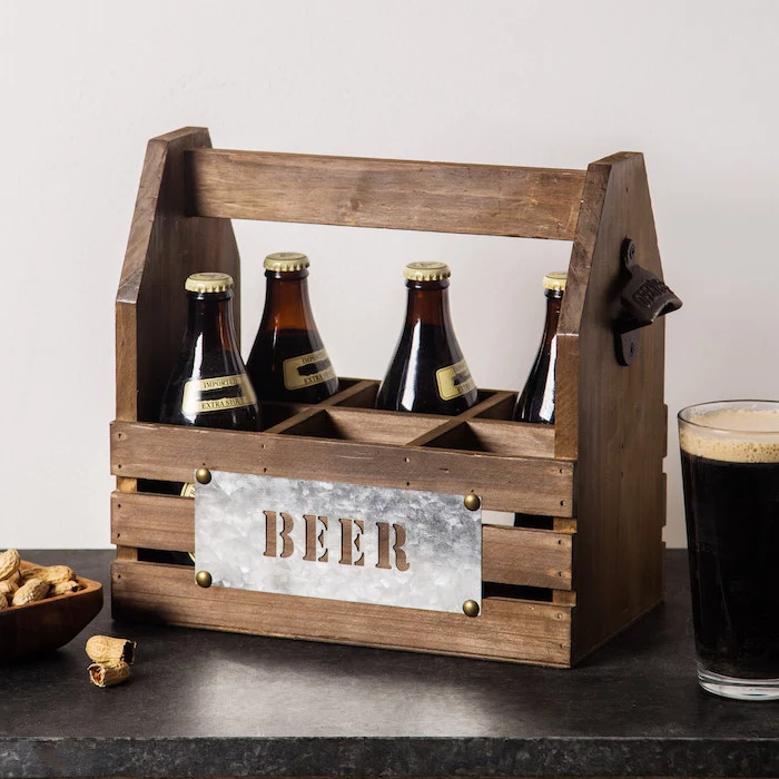 wooden beer caddy, made of wood and holding up to six bottles, gift ideas for men, placed on black granite surface