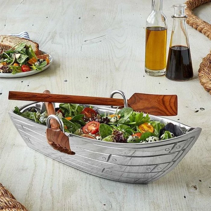 boat shaped salad bowl, with two wooden spatulas on the side, gifts for mom from daughter, placed on wooden table