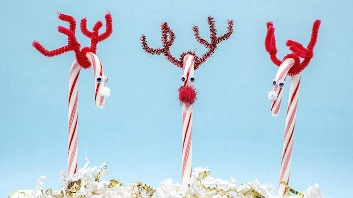 three candy canes, turned into reindeer, christmas crafts for toddlers age 2 3, blue background