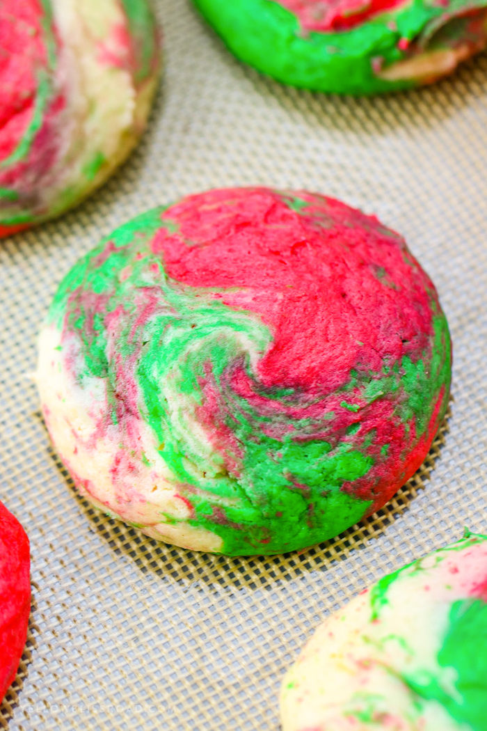 cheesecake cookies, made with mixed green and red dough, decorated sugar cookies, placed on mesh cloth