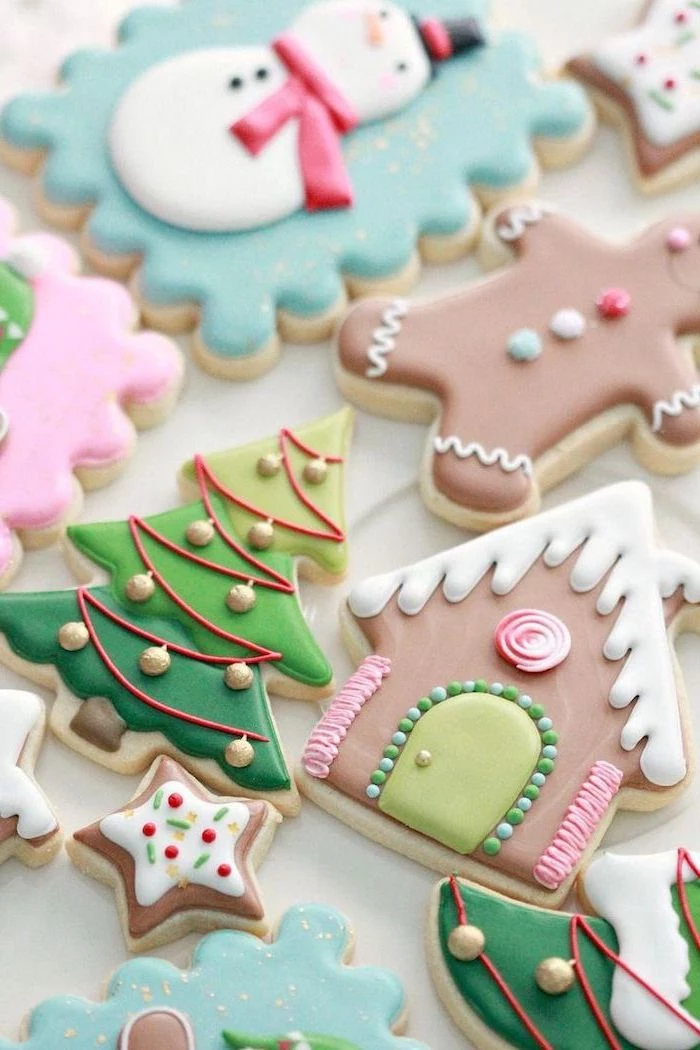 cookie decorating icing, cookies in different shapes, decorated with colorful icing, arranged on white surface