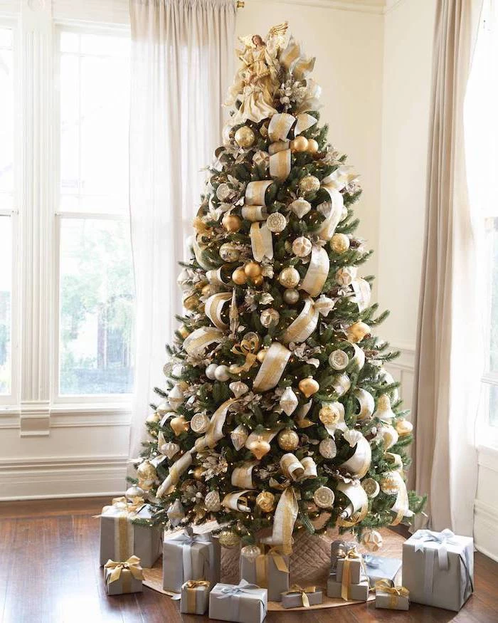 christmas tree decorating ideas, gold ribbon and gold and silver ornaments, on a tall tree with wrapped presents underneath