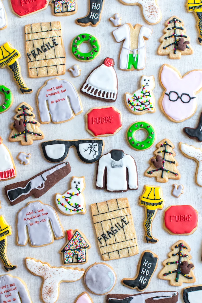 different shaped cookies, placed on white surface, cookie icing, different icing decorations on each cookie