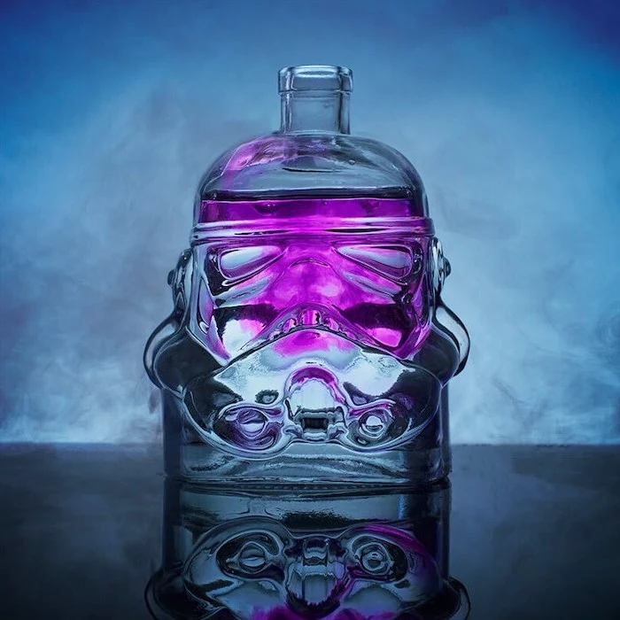 star wars inspired stormtrooper decanter, filled with purple liquid, christmas gifts for men, placed on black surface