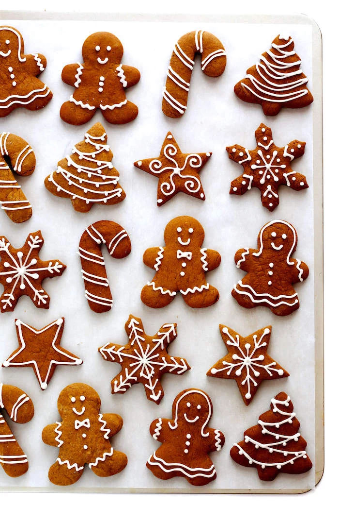 gingerbread cookies in different shapes, cookie icing, gingerbread men and women, snowflakes and candy canes